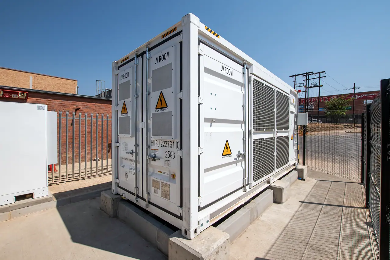 A battery storage container behind a fence at Jubilee Mall